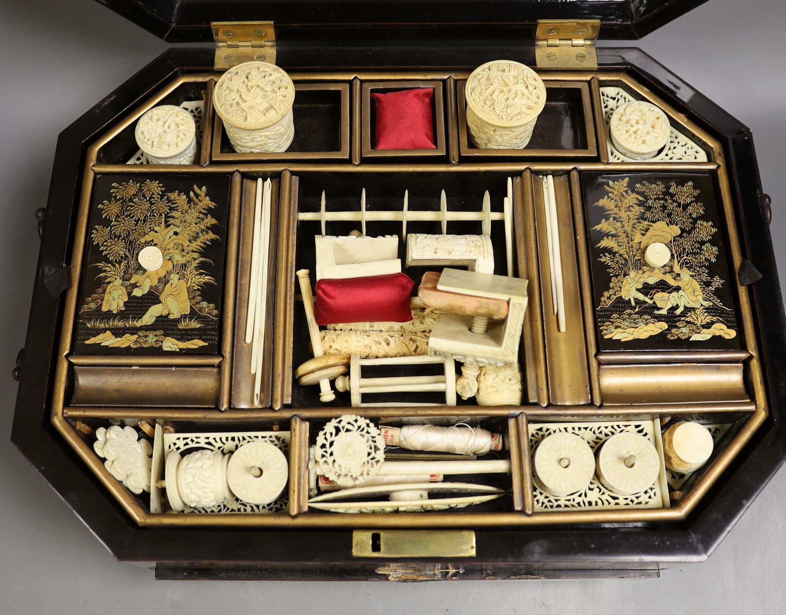 A mid 19th century Chinese Cantonese lacquer workbox with with carved Ivory sewing accessories to the interior, 37cm wide